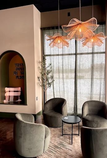 Drip Coffee lounge area with sage green chairs and pendant lights